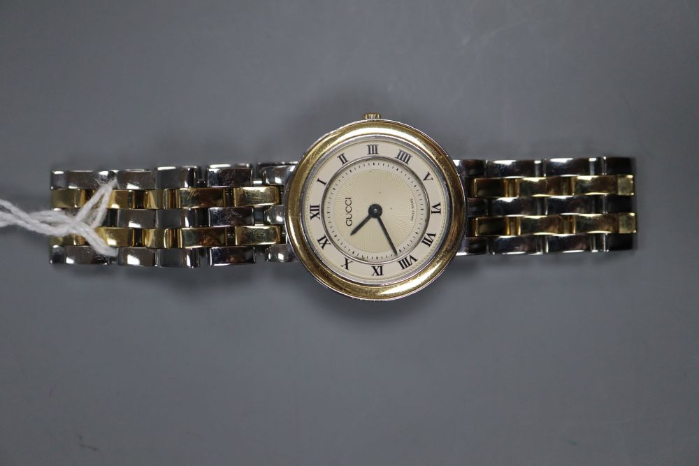 A ladys modern stainless steel and yellow metal Gucci quartz wrist watch, with original receipt and box(a.f.).